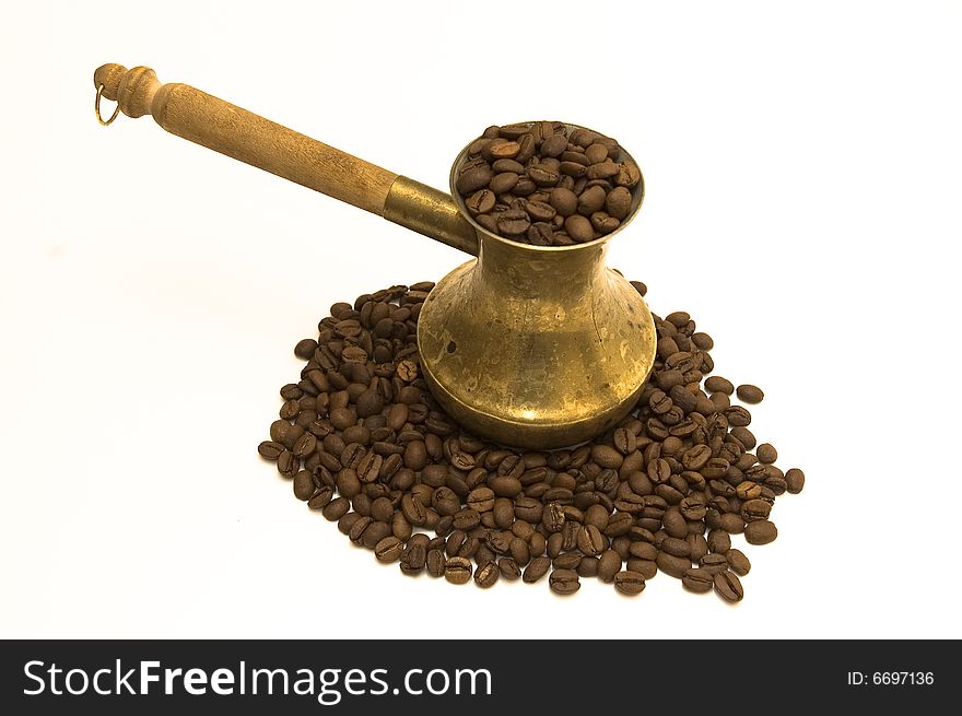 Cezve for coffee with coffee beans isolated on white