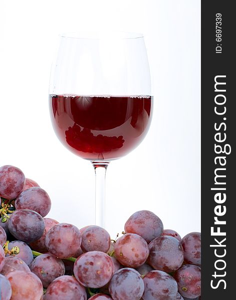 Red grape with glass. White background.