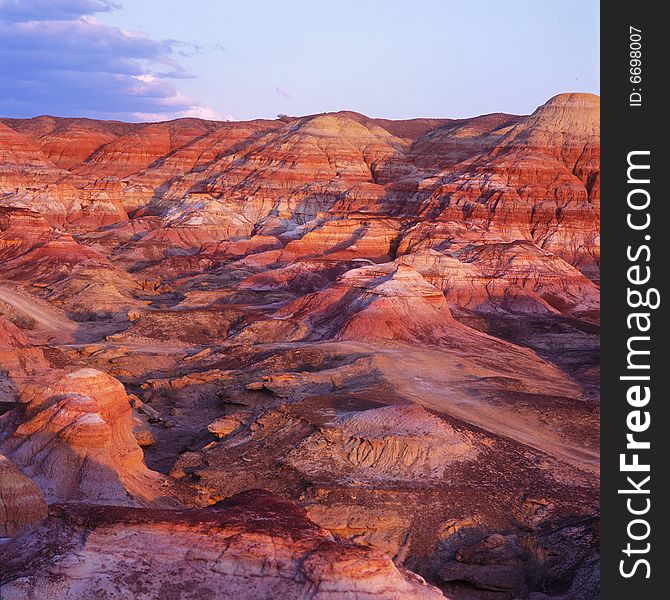 A colorful gorge in sunset. The rock of the gorge becomes red in the sun. It's a view of west China