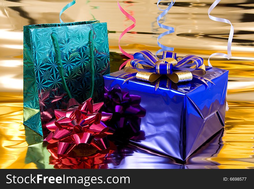 Blue and green gift boxes on a golden background