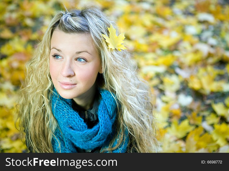 Young woman in autumn yellow forest