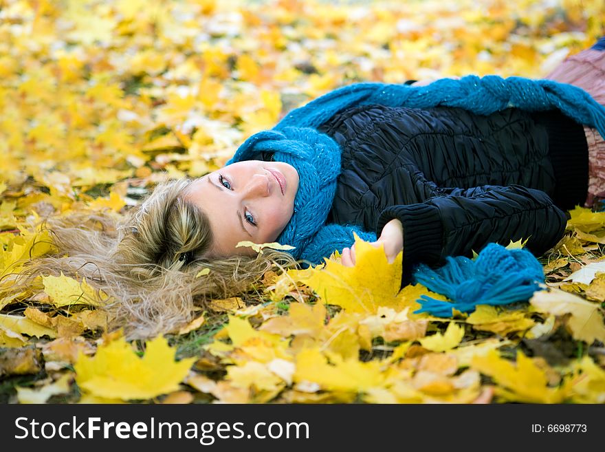 Young woman in autumn yellow forest