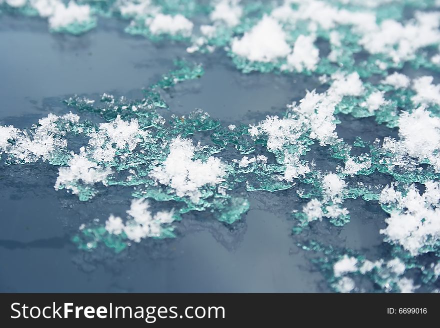 Snow thaws on the glass