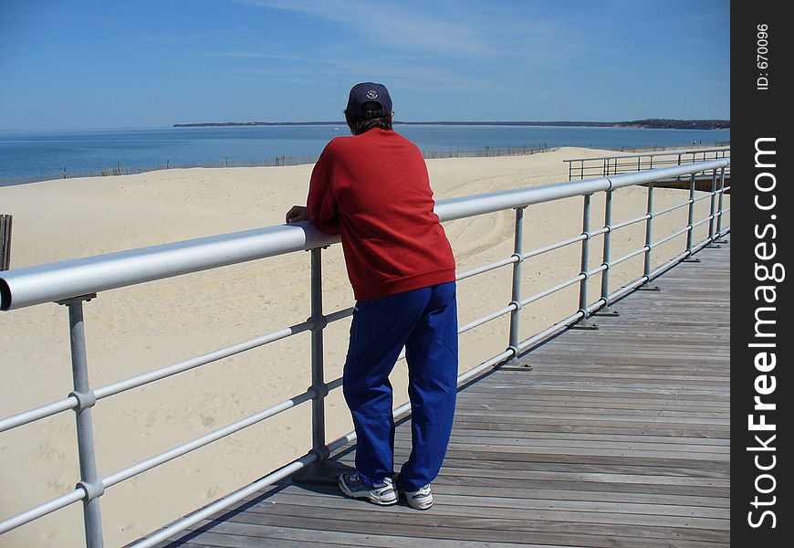 Man taking a breath after exercising on the boardwalk. Man taking a breath after exercising on the boardwalk