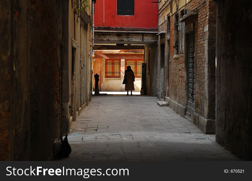 Old Womand walking through an alley in Venice (Venezia, Italy). Old Womand walking through an alley in Venice (Venezia, Italy)