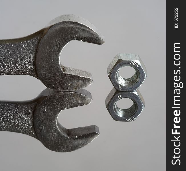 Wrench and nut, reflection