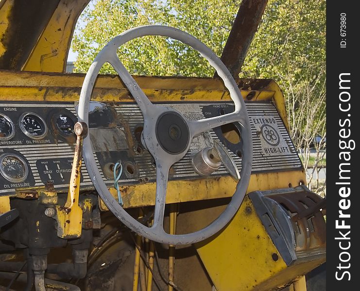 Vintage aging tractor cab with steering wheel. Vintage aging tractor cab with steering wheel