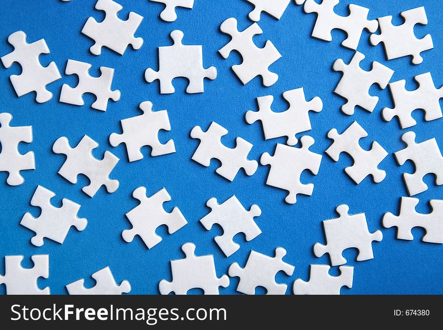 Lost puzzle pieces on blue background. Lost puzzle pieces on blue background