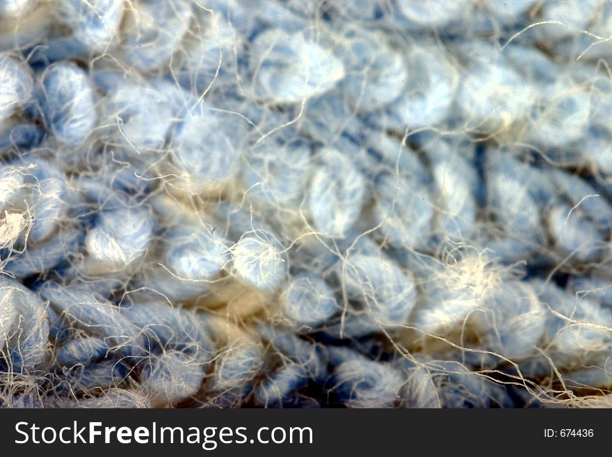 Piece of textile magnified three times. Piece of textile magnified three times