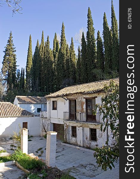 Ruins on the exterior of the ancient Alhambra Palace in Granada on the Costa del Sol in Spain. Ruins on the exterior of the ancient Alhambra Palace in Granada on the Costa del Sol in Spain