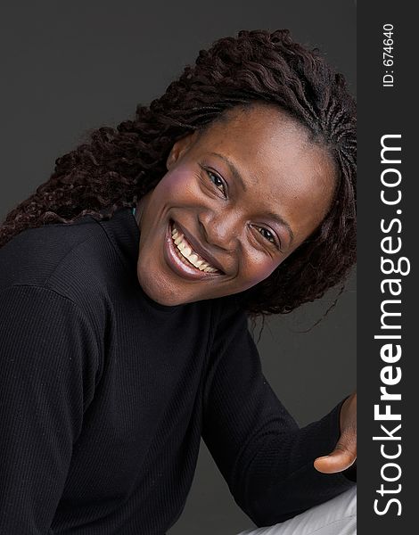 Smiling black girl with dark background