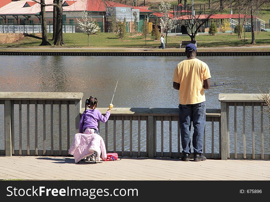 Daddy and daughter fishing at the park