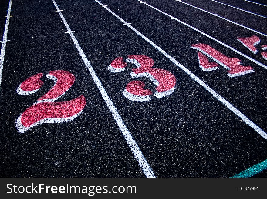 Track & Field Lanes two, three,and four. Black track. Vibrant colors.