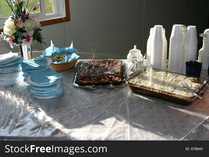 A table set with deserts, styrofoam cups and napkins. A table set with deserts, styrofoam cups and napkins