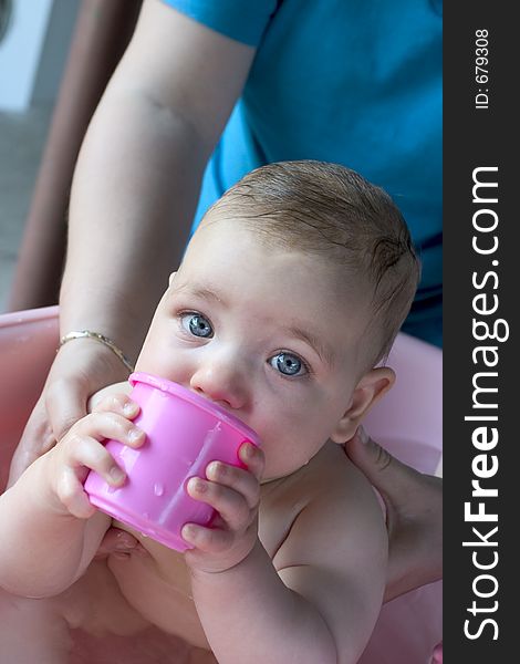 An 8 month Israeli baby girl having bath. An 8 month Israeli baby girl having bath