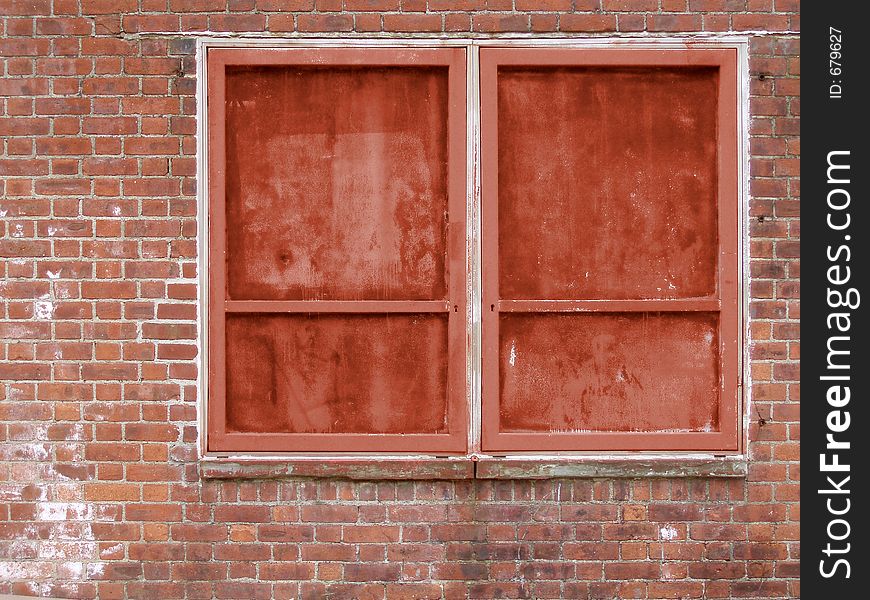 A brick wall with colored windows