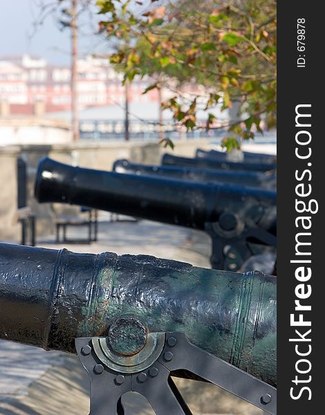 Row of original, cast iron and historical cannons in Gibraltar on a sunny day. Row of original, cast iron and historical cannons in Gibraltar on a sunny day