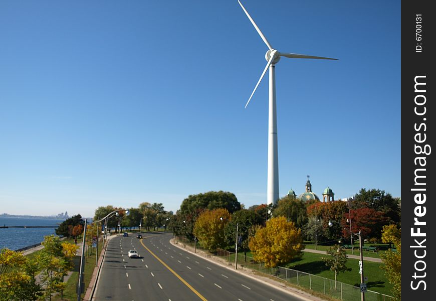 A power generating windmill beside a North American highway. A power generating windmill beside a North American highway.