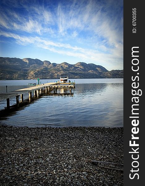 Wide picture overlooking lake with boat and dock. Wide picture overlooking lake with boat and dock