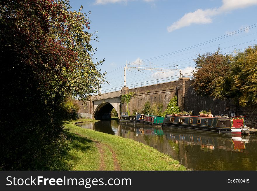 An intercity train crosses a bridge over a canal barge. An intercity train crosses a bridge over a canal barge
