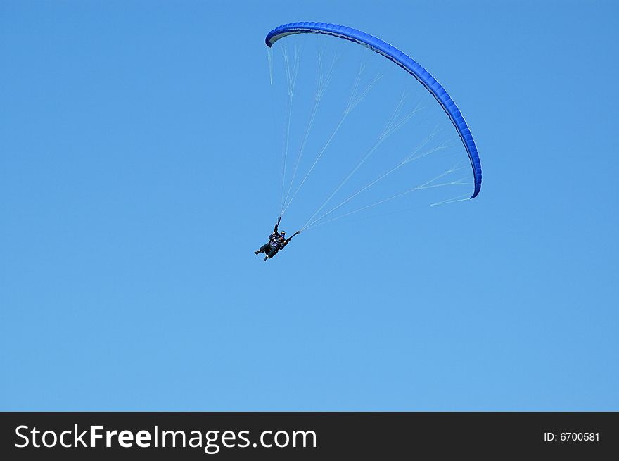 Tandem paragliding in cloudscape area