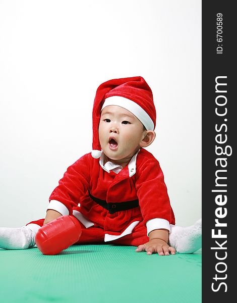 Cute chinese baby boy in a santas outfit. Cute chinese baby boy in a santas outfit