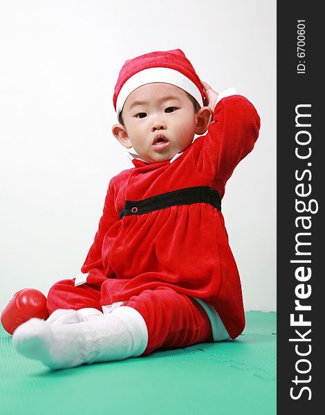 Cute chinese baby boy in a santas outfit. Cute chinese baby boy in a santas outfit