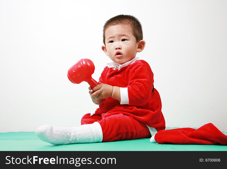 Cute chinese baby boy in a santas outfit. Cute chinese baby boy in a santas outfit