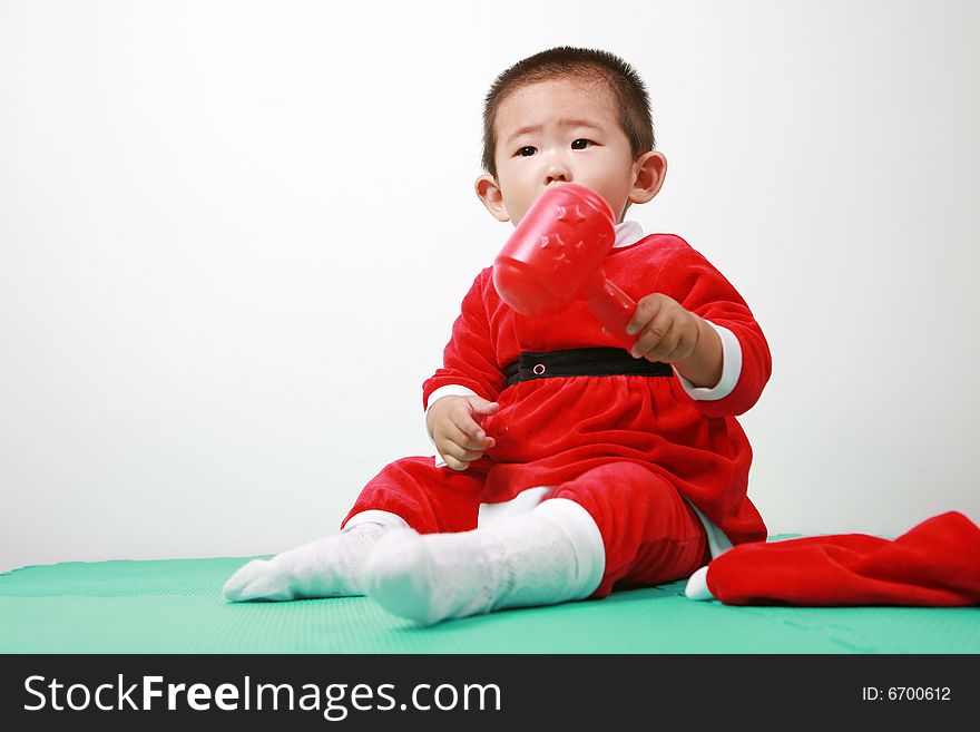 Cute chinese baby boy in a santas outfit. Cute chinese baby boy in a santas outfit