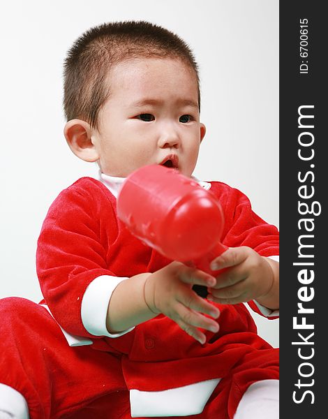 Cute chinese baby boy in a santas outfit. Cute chinese baby boy in a santas outfit