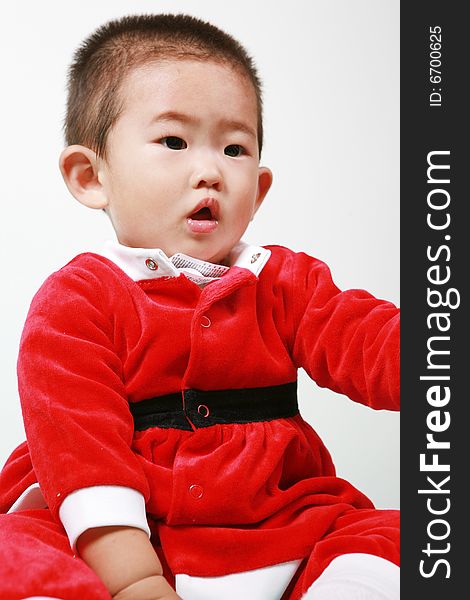 Cute chinese baby boy in a santas outfit. Cute chinese baby boy in a santas outfit