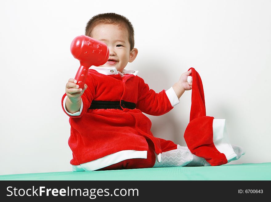 Cute chinese baby boy in a santas outfit. Cute chinese baby boy in a santas outfit