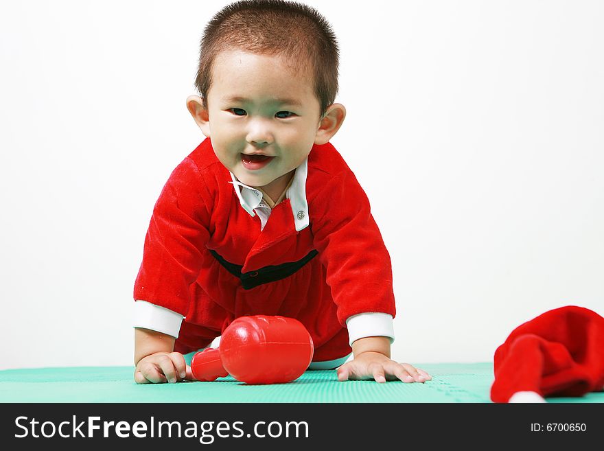 Cute chinese baby boy in a santas outfit. Cute chinese baby boy in a santas outfit