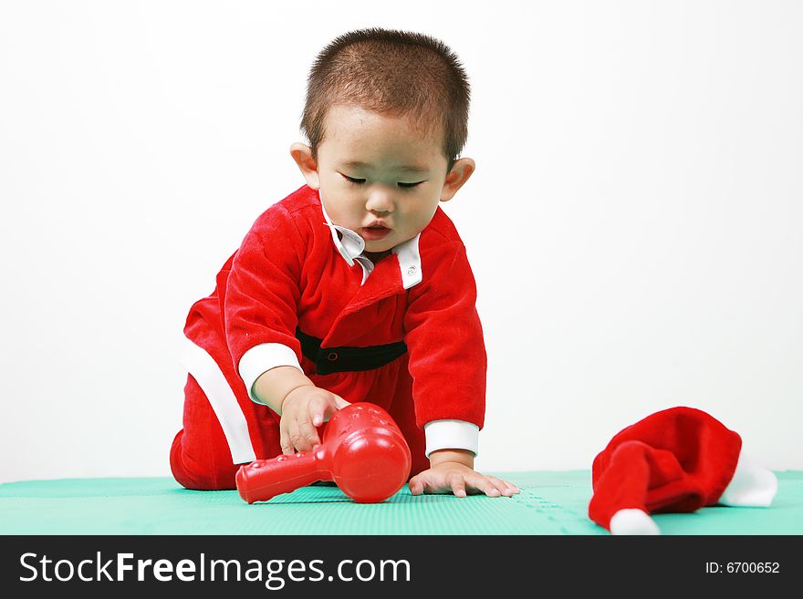 Cute chinese baby boy in a santas outfit. Cute chinese baby boy in a santas outfit