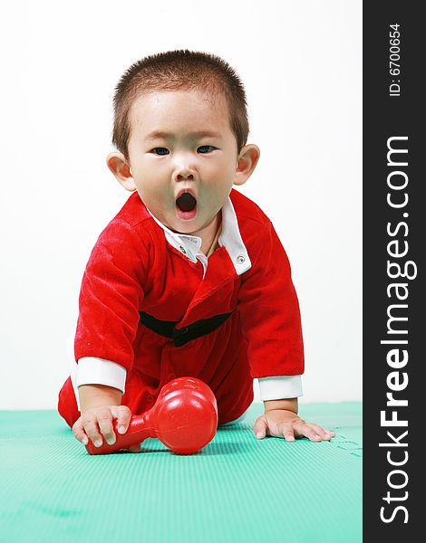 Cute chinese baby boy in a santas outfit. Cute chinese baby boy in a santas outfit