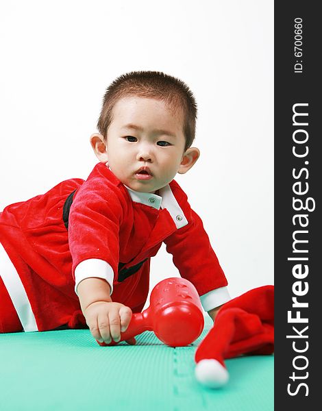 Cute chinese baby boy in a santas outfit. Cute chinese baby boy in a santas outfit