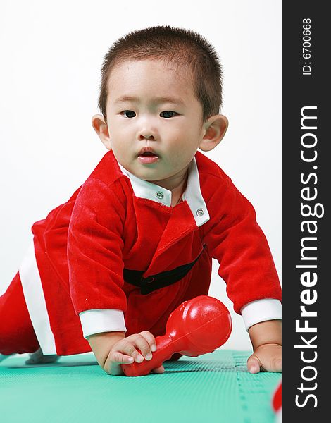 Cute chinese baby boy in a santas outfit. Cute chinese baby boy in a santas outfit