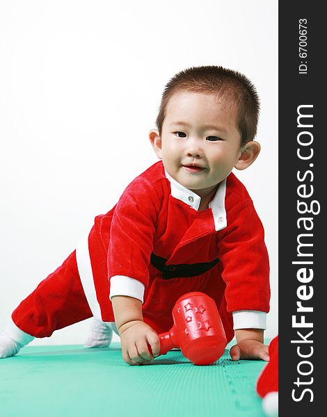 Cute chinese baby boy in a santas outfit. Cute chinese baby boy in a santas outfit