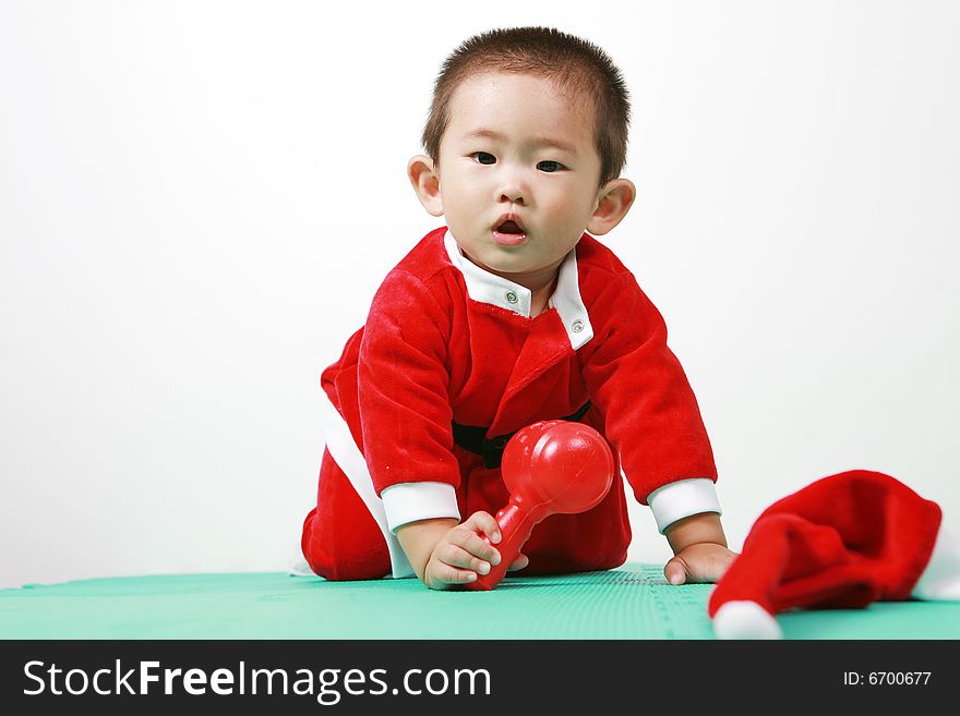 Cute chinese baby boy in a santas outfit. Cute chinese baby boy in a santas outfit