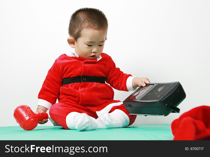 Cute chinese baby boy in a santas outfit. Cute chinese baby boy in a santas outfit