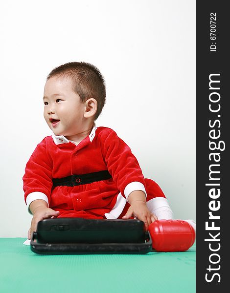 Cute chinese baby boy in a santas outfit. Cute chinese baby boy in a santas outfit