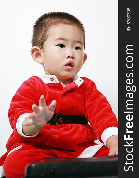 Cute chinese baby boy in a santas outfit. Cute chinese baby boy in a santas outfit