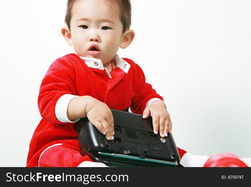 Cute chinese baby boy in a santas outfit. Cute chinese baby boy in a santas outfit