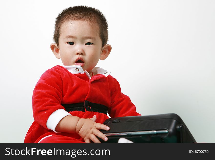 Cute chinese baby boy in a santas outfit. Cute chinese baby boy in a santas outfit