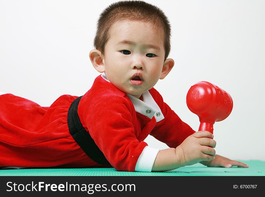 Cute chinese baby boy in a santas outfit. Cute chinese baby boy in a santas outfit