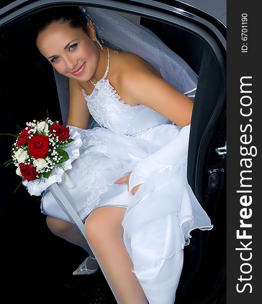 Portrait of the smiling bride in the car