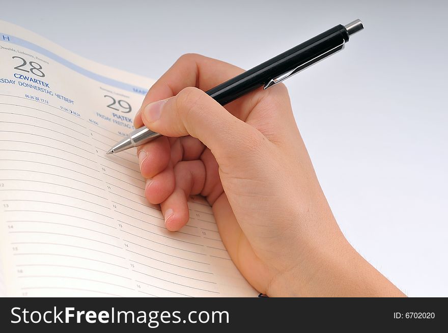 Image of hand writing in notebook. Image of hand writing in notebook