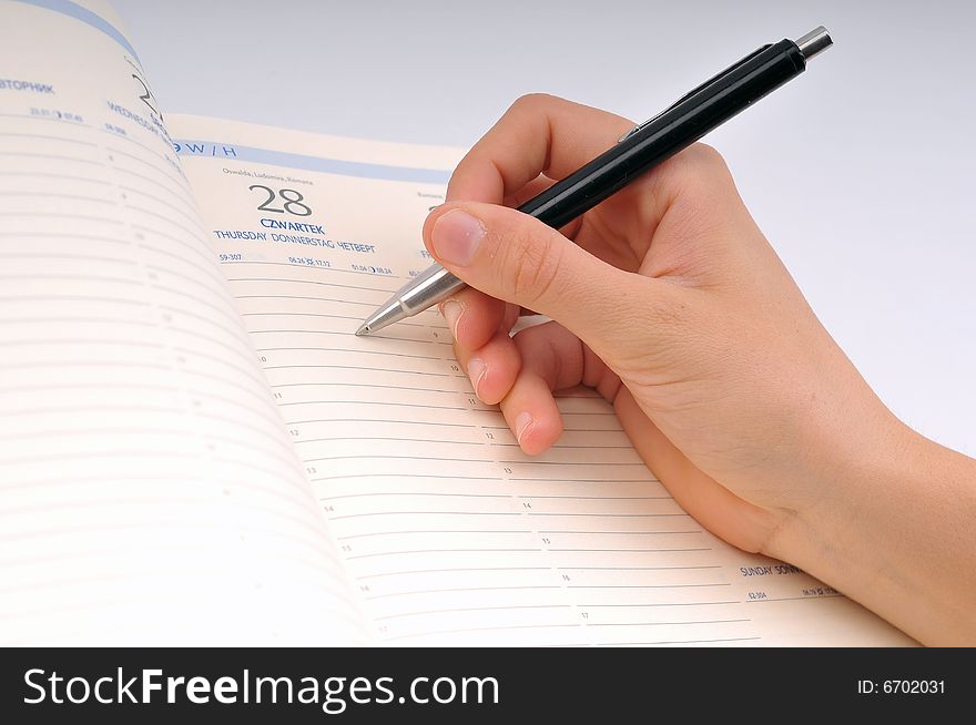 Image of hand writing in notebook. Image of hand writing in notebook