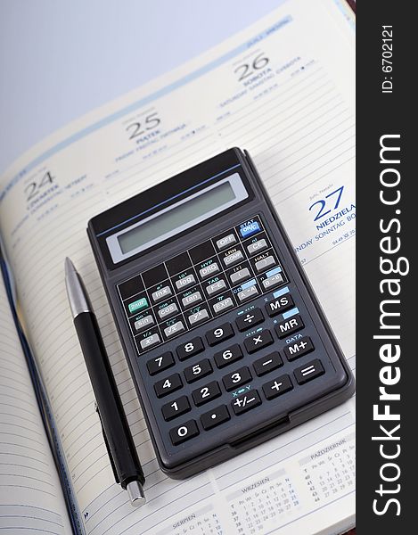Image of year planner with pen and calcularor - budget time. Image of year planner with pen and calcularor - budget time