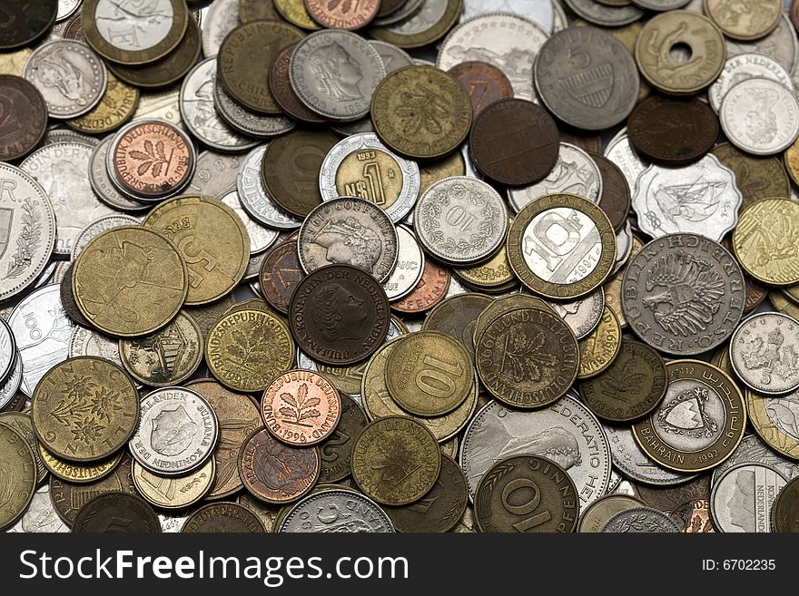 Loads of coins from around the world, isolated. Loads of coins from around the world, isolated.